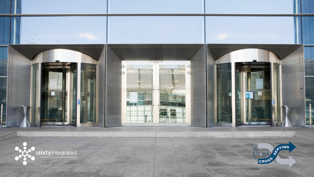 Commercial doors on a modern, metal building with the 3Sixty Integrated and Cross-SERVE logos