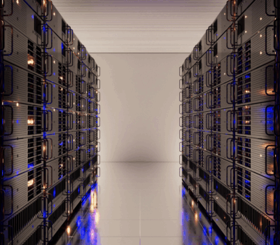 Modern data center with illuminated server racks representing secure on-prem infrastructure in a hybrid cloud security system.
