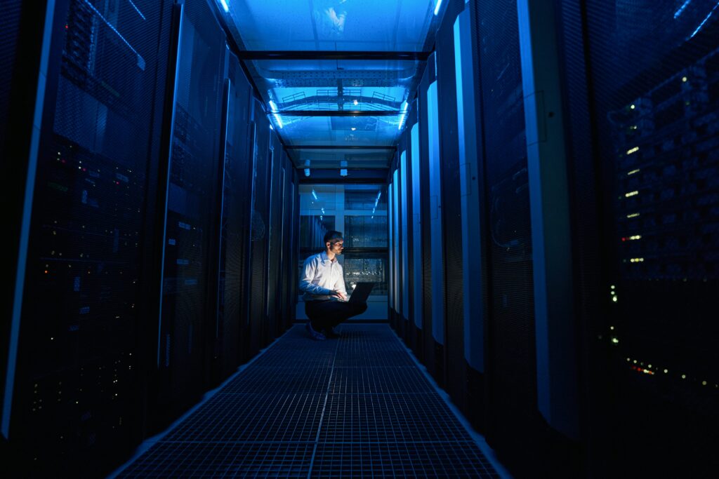 IT professional monitoring data-driven security in a modern server room to prevent downtime.